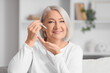 © Pixel-Shot - Mature woman applying serum with collagen at home