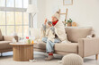 © Pixel-Shot - Sick elderly woman eating soup on sofa at home