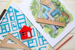 © Pixel-Shot - Zoning plans with house figure and rulers on white wooden background