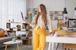 © Pixel-Shot - Female web designer with laptop in office