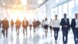 © Rendah - Blurred Business Professionals Walking in Modern Office Building.