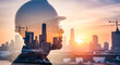 © Sianna - Worker looks towards city skyline during sunset with construction cranes in the background highlighting the growth of the urban area and the role of industry in development