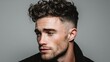 © mila103 - Young caucasian male with stylish curly haircut facing right.