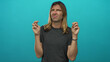 © Krakenimages.com - Man with long blond hair making finger quotes gesture with both hands and a skeptical expression in a studio; skepticism humor.