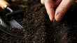 © Natalia - Careful hand of a gardener planting a small organic seed into dark fertile soil. Realistic 3D render style.