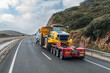 © M. Perfectti - Special transport truck carrying large construction machinery on a trailer, rear view