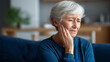 © Kateryna - Faceless elderly woman at home touching cheek and grimacing in pain severe toothache or jaw discomfort dental emergency oral pain suffering senior health crisisy with copy