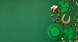© Iuliia Metkalova - St. Patrick's Day Leprechaun Hat, Gold Coins, Shamrocks and Party Favors on Green Background.