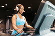 © ADDICTIVE STOCK - Woman exercising in a hotel gym with headphones