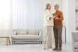 © New Africa - Lovely senior couple dancing together at home. Space for text