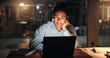 © SparkPix/peopleimages.com - Man, tired and laptop at night in office with review, article or bored for deadline. Creative person, overtime and computer for research, feedback and exhausted for draft task in publishing company