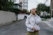 © Nazareno - Bald woman talking on smartphone walking on street
