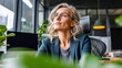 © Yevheniiya - A professional blonde woman in glasses looks up with a thoughtful expression in her office.