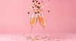 © KB Kalmati - Sophisticated party toast featuring crystal champagne glasses and falling gold discs against a soft, monochromatic pink studio setting.