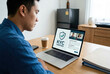 © Pixel Alchemist - KYC verified certificate satisfaction guarantee policy exam law solution approval display on laptop screen while man work remote from home office desk Concept of compliance