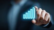 © Jayk - Businessman's finger touching a glowing blue bar graph indicating growth and success