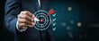 © BOTAHRY DEX - Business goal setting concept with businessman using digital stylus to target center of dartboard, symbolizing strategic planning, objective alignment, achievement checklist for organizational success