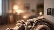© TensorSpark - Smart thermostat on wall controlling hvac for comfortable home heating, cozy blanket in foreground conveys warmth and comfort.