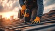 © Oleh - Construction worker wearing protective gloves installing new roof tiles on a house during renovation, using a powerful cordless electric drill against a warm sunset sky