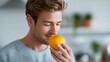 © Jane_S - Young caucasian male enjoying fresh orange in bright kitchen