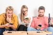 © Volodymyr - Friends sit together but all look at their phones. Group friends with social media concept. Group of people disconnected. Friends absorbed in devices. Technology silent distance.