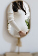 © Nataliya - Reflection of a pregnant woman in a mirror.