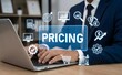 © Gupta - Businessman analyzes pricing strategies and market data on a laptop surrounded by digital icons.