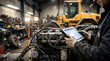 © Art_spiral - Heavy equipment mechanic running digital diagnostics on diesel engine with tablet in industrial workshop and construction machinery background for maintenance and repair