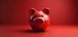 © Vadym - Red piggy bank sits on red surface against plain red background. This simple icon represents saving money financial goals and personal finance planning for future investment.