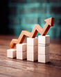 © HatoruCreators - Financial trend bars rising high on dark wooden surface.