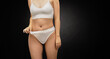 © SergeiPh - A woman with a beautiful figure poses for a photo in a white bikini and white panties. The image exudes confidence. Conceptually, it's about healthy eating and dieting.