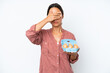 © luismolinero - Young hispanic woman holding eggs isolated on white background covering eyes by hands. Do not want to see something