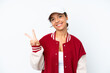 © luismolinero - Young hispanic woman wearing a baseball uniform isolated on white background smiling and showing victory sign