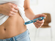 © Facundo - Woman Injecting Insulin or Medication into Abdomen with Medical Pen, Diabetes and Weight Loss Treatment Concept