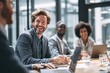 © Microstocke - Diverse business team laughing together in modern office during meeting