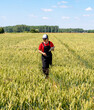 © Barillo Images - Woman farmer inspecting wheat with digital tablet in growth season in spring.
