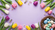 © Vyatcheslav - Easter background with colorful spring tulips and a nest of speckled eggs. Holiday flat lay composition on a purple background. Top view with copy space for text