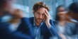 © vetrana - Man shows signs of anxiety during a meeting in an office with colleagues