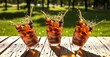 © CHANCHALA  SARKAR - Refreshing cola drinks with ice splashing dramatically in glasses on a rustic wooden table outdoors on a sunny day