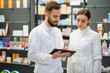 © Serhii - Pharmacists using digital tablet for inventory and healthcare information