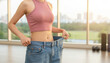 © Hound - Successful Weight Loss: Woman Demonstrating Progress with Loose Jeans