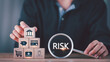 © chaylek - Financial analysts assess business risks using symbolic blocks and magnifying glass tools, representing credit risk, insurance planning, consumer protection, and structured financial management.