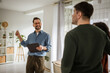 © Miljan Živković - Real estate agent showing potential buyers a modern apartment