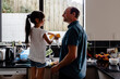 © NZstockphoto - Father teaching daughter how to wash dishes in the kitchen