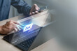 © Garun Studios - Business professional composing email message on laptop with digital interface and smartphone. Concept of email marketing, electronic mail communication, online campaign, attachments.