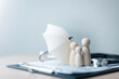© Garun Studios - Health insurance concept with family figures protected by umbrella and medical tools. Represents healthcare coverage, insurance policy, patient care, wellness planning, and medical security.