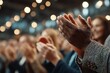 © mansoor - Diverse audience applauding in a modern conference setting with bokeh lights