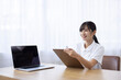 © hidez - Smiling Young Woman in White Uniform Talking with Patient While Filling Medical Questionnaire