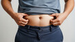 © Tegar Ramadhani - Close-up of Overweight Person Pinching Excess Belly Fat