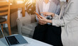 © Sirikarn Rinruesee - Businesswomen reviewing paperwork in conference room